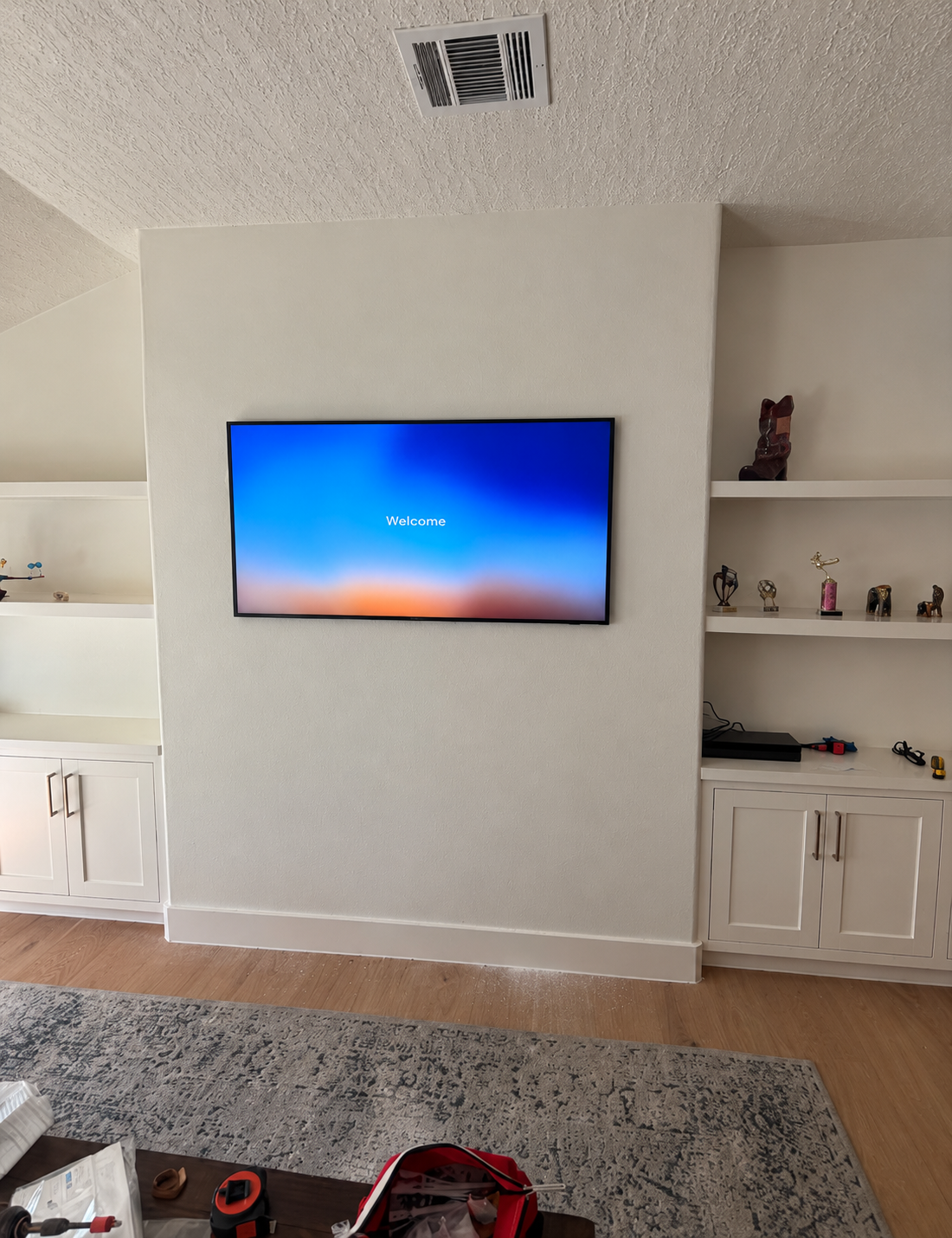 Wall-mounted television between built-in shelves